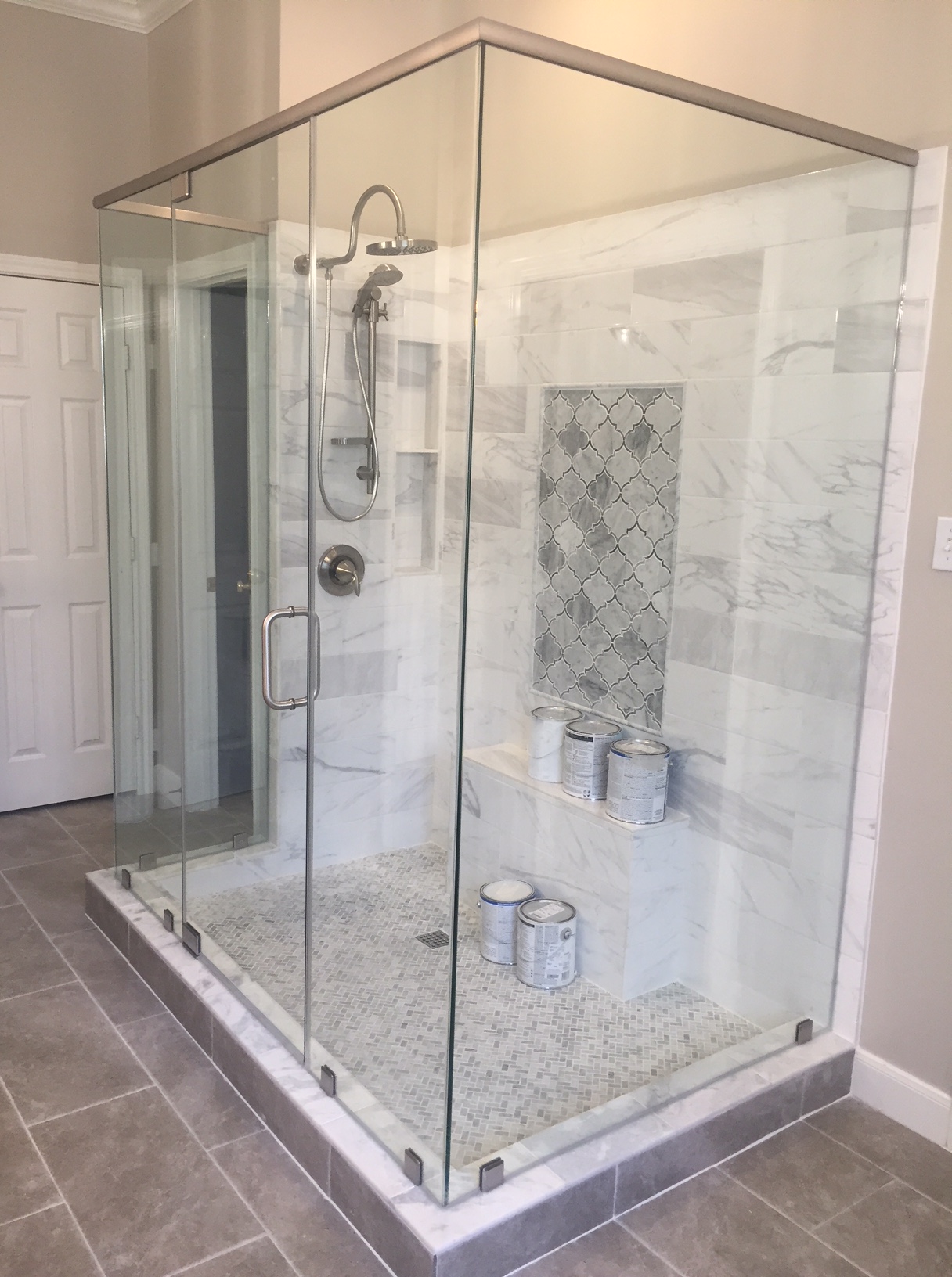 Frameless Walk-In with Marble Surround installed by Texan Glass in The Woodlands, TX